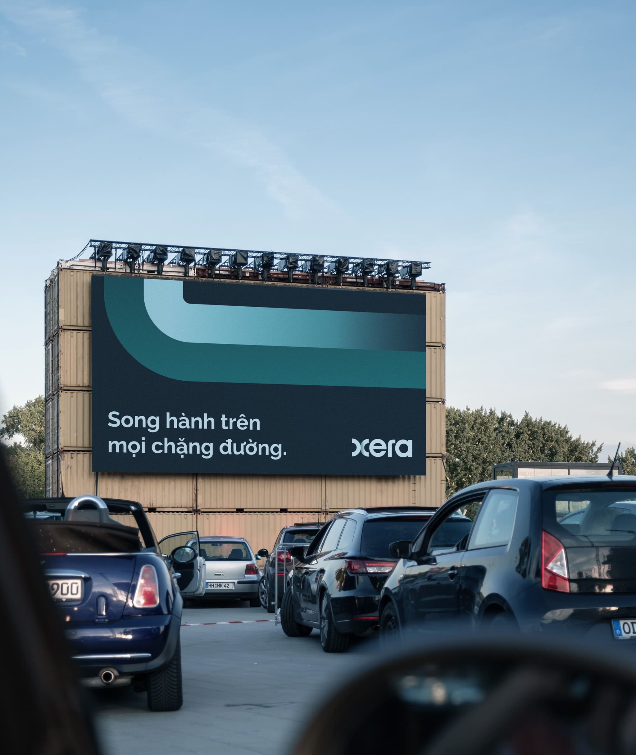 Billboard mockup featuring “Song hành trên mọi chặng đường” by Xera, with cars in the foreground.