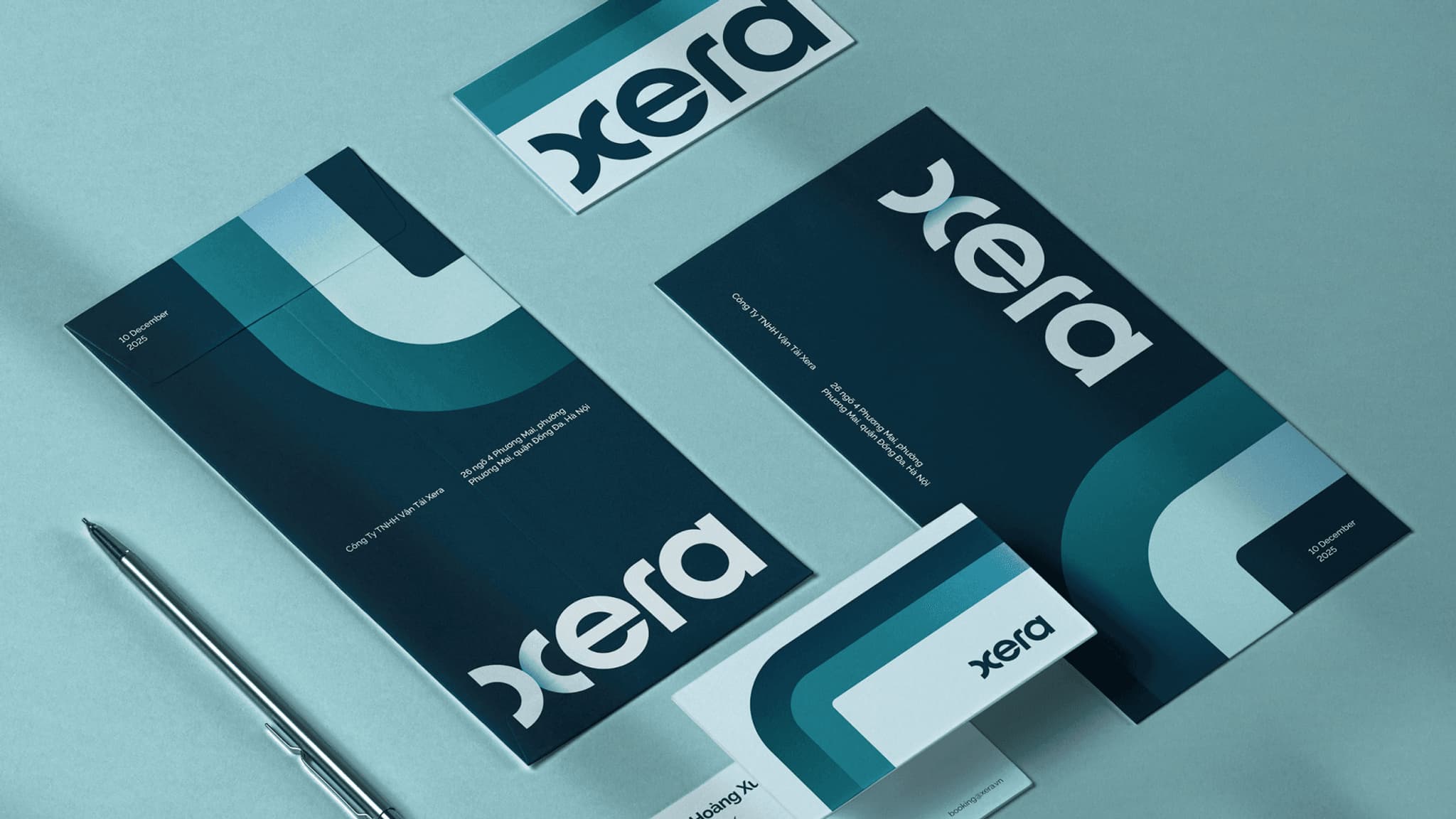 Branded stationery featuring the logo of Xera, including business cards and letterhead on a light blue surface.